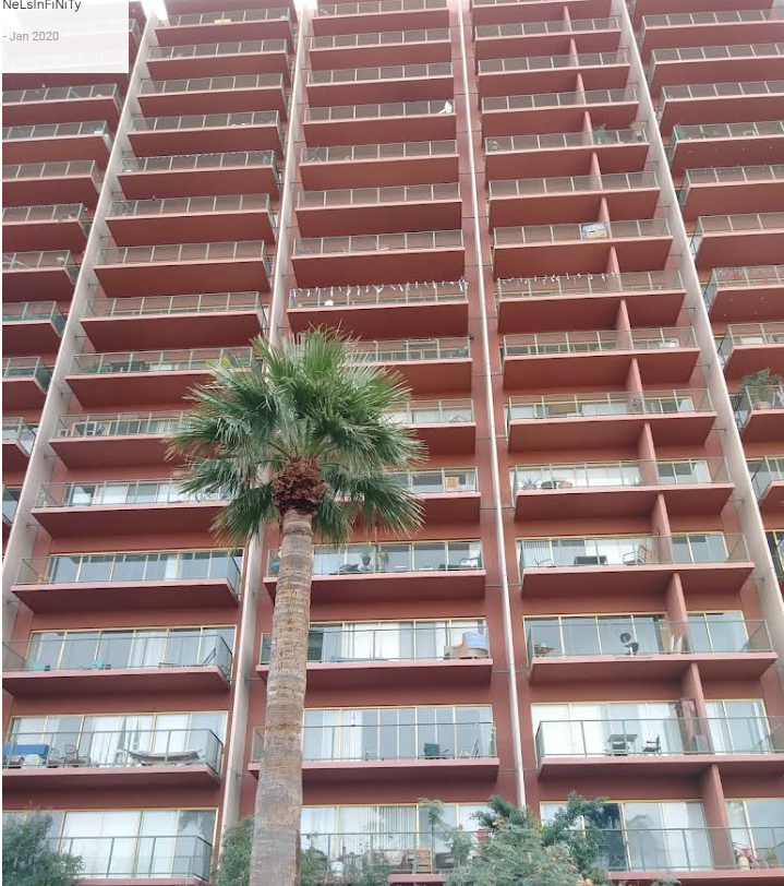 The rhythm of terracotta balconies across the tower's facade