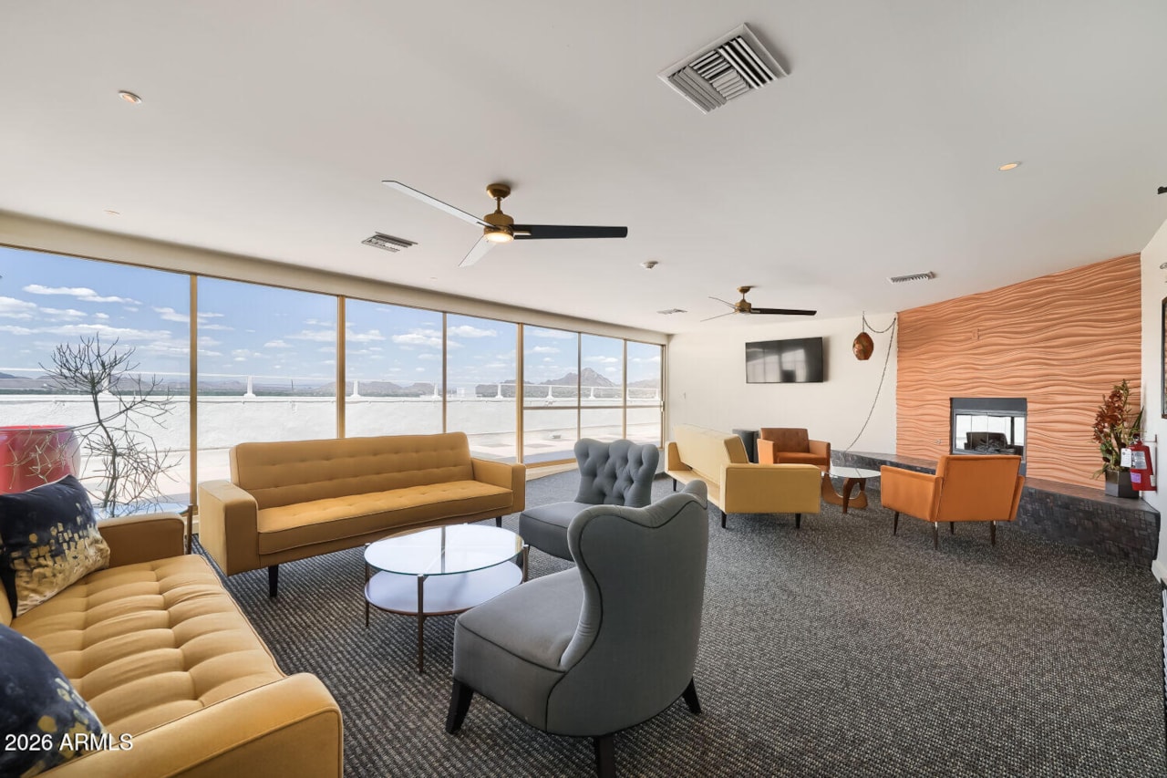 17th-floor community lounge with floor-to-ceiling glass and mountain views
